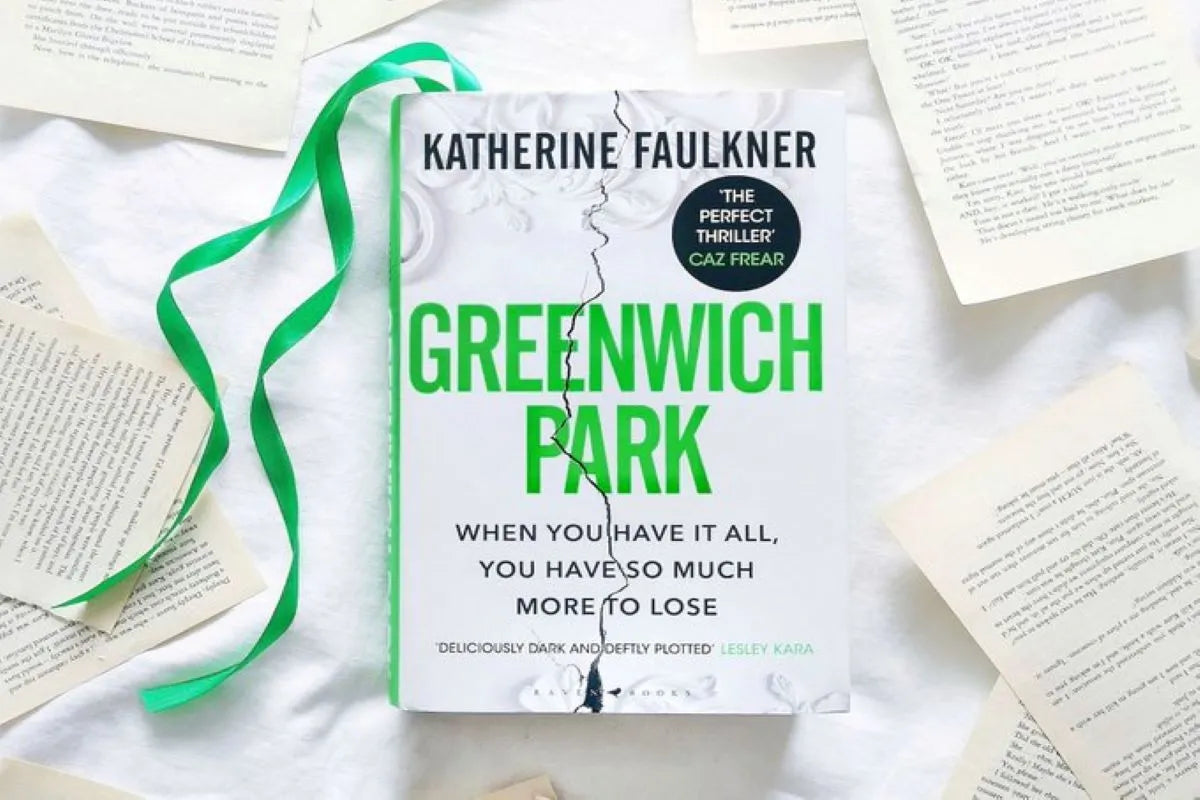 The book 'Greenwich Park' by Katherine Faulkner is displayed on a white fabric background surrounded by scattered book pages, with a green ribbon bookmark draped to the left.